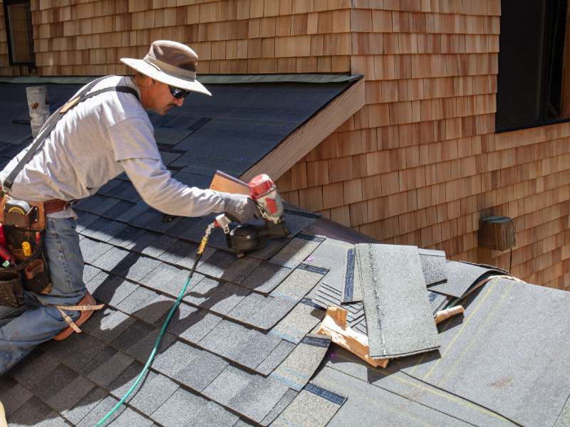 roofer nailing shingles