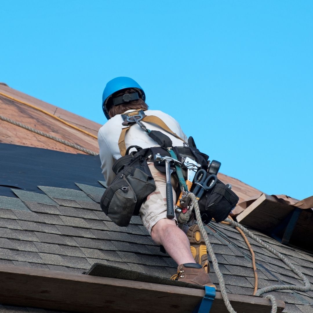 someone with a harness on a roof